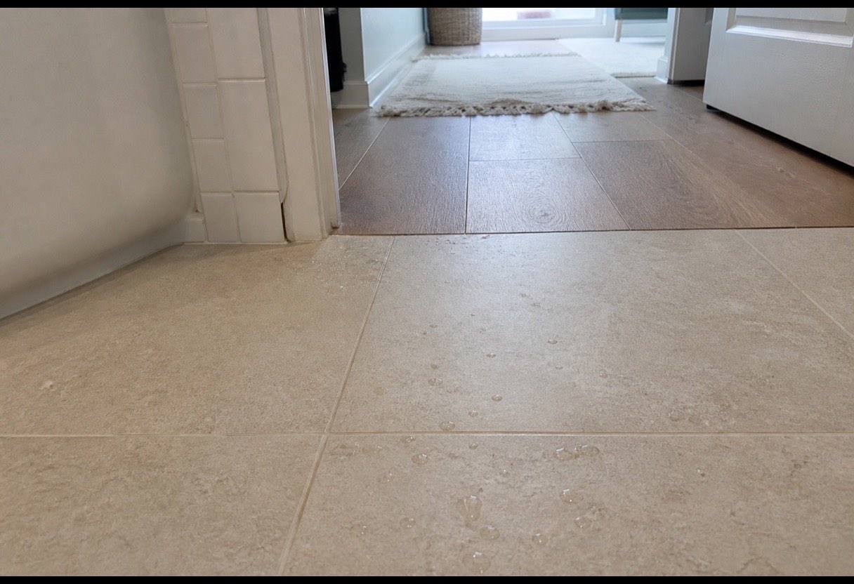 A flush transition at the doorway. No strip to catch a foot, planned before the materials were ordered.